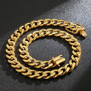 Polished gold stainless steel Cuban link necklace with thick chain links on black background