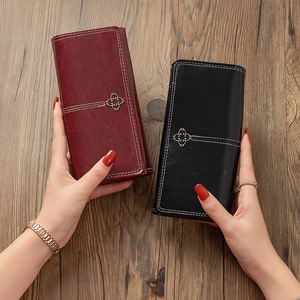 Vintage long wallet for women featuring cross metal charm and contrast stitching details