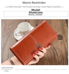 Brown leather wallet with floral metal buckle detail and litchi grain texture