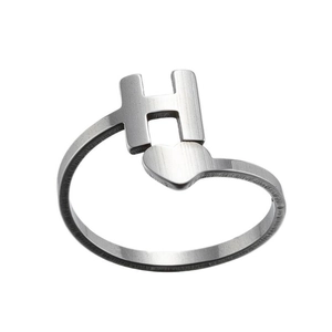 Detailed view of silver brushed steel ring featuring letter H and heart design