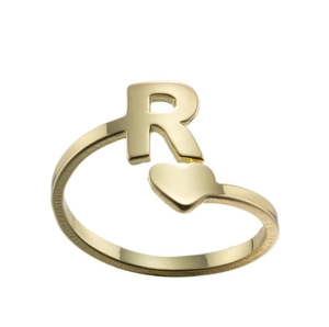 Detail of gold open ring featuring letter R and heart design on white background