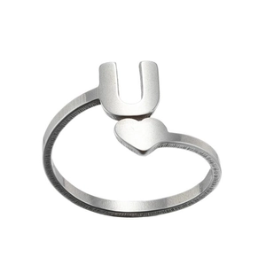 Detail showing letter U and heart design with brushed metal texture on a silver ring