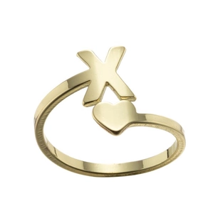 Macro shot of gold-plated crossover X and heart design ring with a polished glossy finish