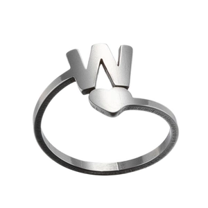 Close-up of silver letter W ring with heart shape and matte stainless steel finish