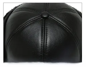 Detailed close-up of premium black leather baseball cap top with six-panel stitching design