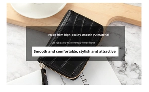 Close-up of black crocodile embossed PU leather wallet with golden metal zipper detail