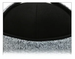 Detail of precise stitching on winter cap crown with premium grey faux fur and wool fabric