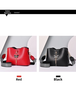 Detail of fashion crossbody bags in red and black with gold butterfly charms and straps
