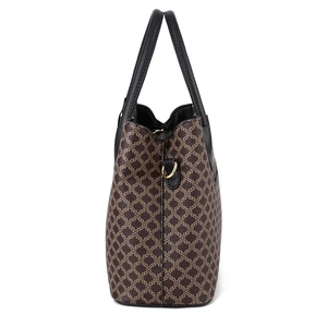 Side view of vintage printed handbag with black leather trim and large capacity storage
