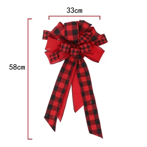 Detail of red and black buffalo plaid Christmas tree topper bow measuring 33x58cm