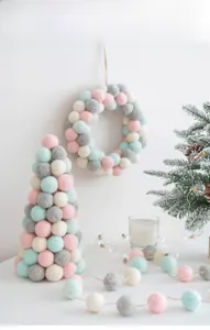 Close-up of handmade macaron wool felt ball Christmas tree and festive ornaments