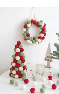 Nordic wool felt Christmas tree ornaments with red and green balls in a cozy festive setting