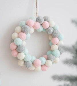 Detail of macaron wool felt ball wreath with hanging rope for Nordic Christmas decor