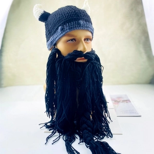 Detail of Viking helmet knit hat with white horns and black yarn beard mask on model