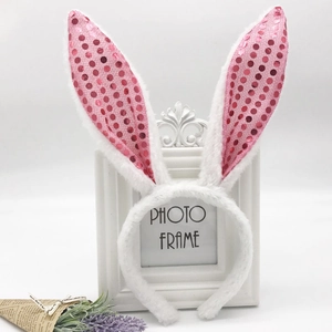 Detail showing plush white rabbit ears with glittery pink sequins and soft velvet fabric
