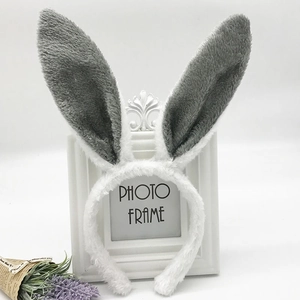 Detail view of plush white and grey bunny ears headband with soft faux fur texture