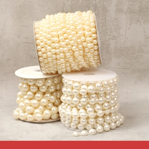 Macro detail of three rolls of cream beige ABS artificial pearl beads for DIY crafts