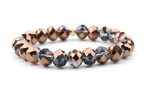 Macro shot of multi-faceted bronze and translucent gray glass crystal beaded bracelet