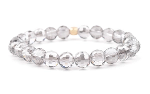 Macro shot of faceted crystal glass beads with a single gold accent bead detail