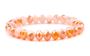 Detailed close-up of faceted peach crystal beads on a handmade stretch bracelet