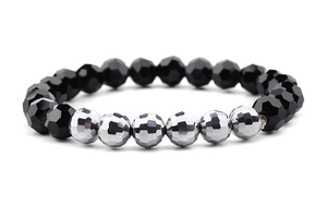 Detailed macro view showing multifaceted black and silver faceted crystal beads on elastic bracelet