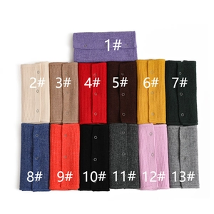 Detail view of colorful knitted neck warmers with snap buttons in 13 color options