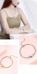 Detail of heart necklace and double-layer bracelet in polished silver and gold finish