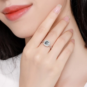Luxury square zircon engagement ring with silver halo setting on a woman's finger