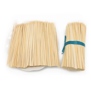 Natural bamboo BBQ skewers for grilling and appetizers in a neat bundle on a plate