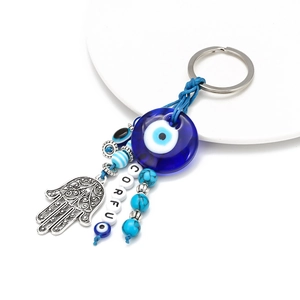 Blue Evil Eye and Hamsa Hand keychain with Corfu beads on white display base