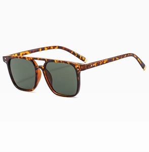 Detail of tortoise frame square sunglasses with double bridge and dark green lenses