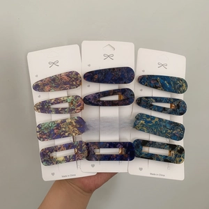 Set of 12 colorful acrylic hair clips with marble patterns in square and teardrop shapes