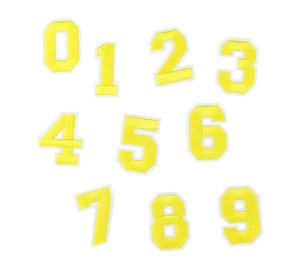 Detailed view of yellow embroidered number patches from 0 to 9 on a white background