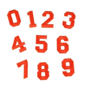 Detail of vibrant orange embroidered number patches from 0-9 for clothing accessories