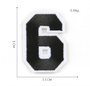 Detailed view of number 6 embroidered patch in black and white measuring 5cm x 3.5cm