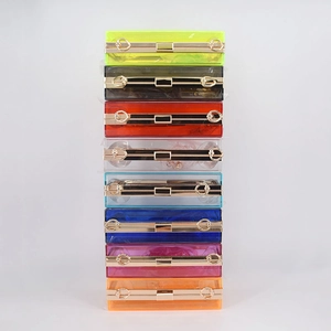 Detailed top view of various colored acrylic clutch bags with metallic gold frames