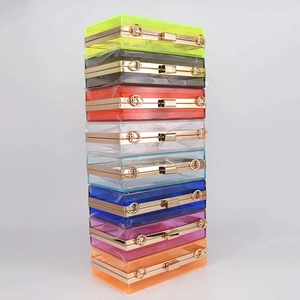Detailed close-up showing eight colors of transparent acrylic evening clutch bags with gold frames