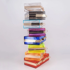 Detailed stack of multi-color transparent acrylic clutch bags with gold metal frames