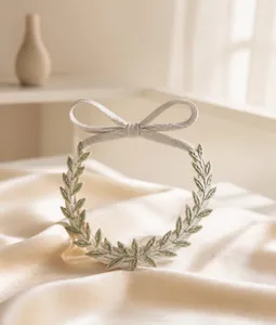 Dettaglio della fascia da sposa bianca con foglie e nastri in seta delicati