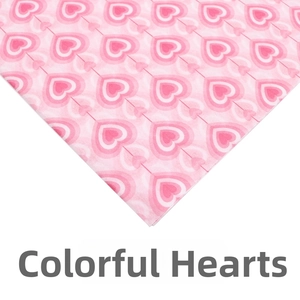 Close-up of pink nested heart patterns on Christmas tissue paper for gift wrapping