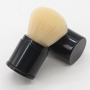 Detail of retractable makeup brush with black casing and soft yellow bristles on white background