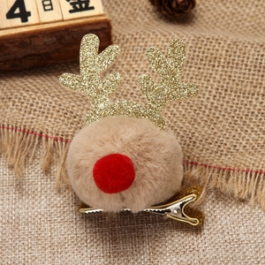 Barrette de Noël renne avec bois dorés et pompon en peluche marron sur fond de jute