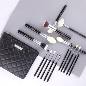 Detail of 16 professional makeup brushes with a black quilted storage pouch