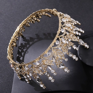 Macro shot of gold leaf crown with sparkling clear crystals on professional black background