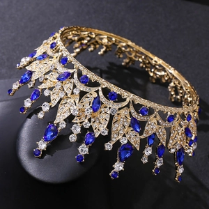 Detailed close-up of golden leaf tiara with deep blue crystals and teardrop rhinestones