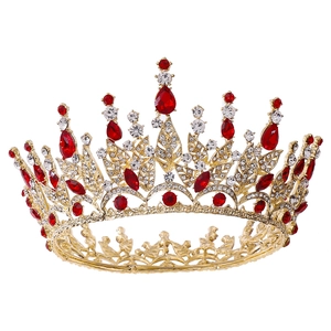Detailed close-up of a golden baroque bridal crown with red crystals and leaf design