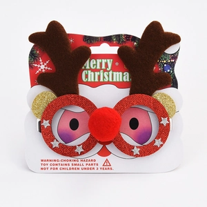 Close-up of Christmas reindeer glasses with glitter frame, brown antlers and red pom-pom nose