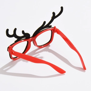 Detail of red Christmas glasses featuring black reindeer antlers and soft flocking texture