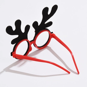 Detail of red Christmas glasses frame with black felt antlers for festive parties