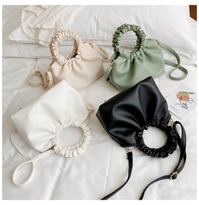 Detail view of stylish crossbody bags with unique ruched handles in four soft colors